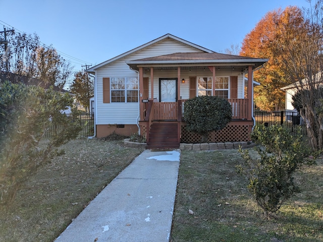 bungalow-style home featuring a front lawn and a porch