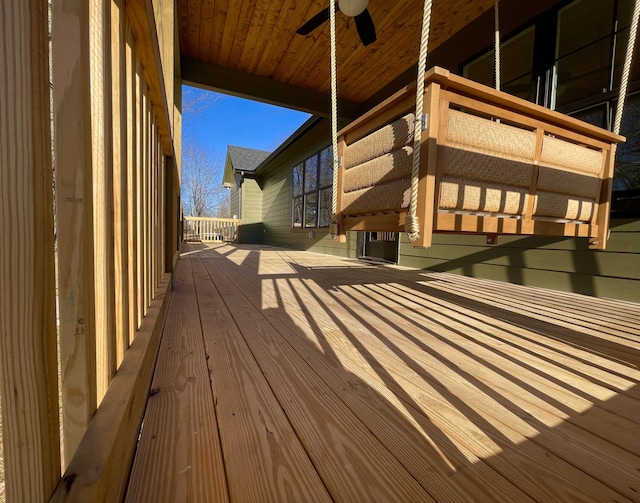 wooden deck featuring ceiling fan