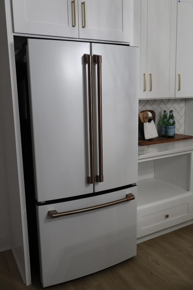 interior details featuring high end refrigerator, backsplash, dark hardwood / wood-style flooring, and white cabinets