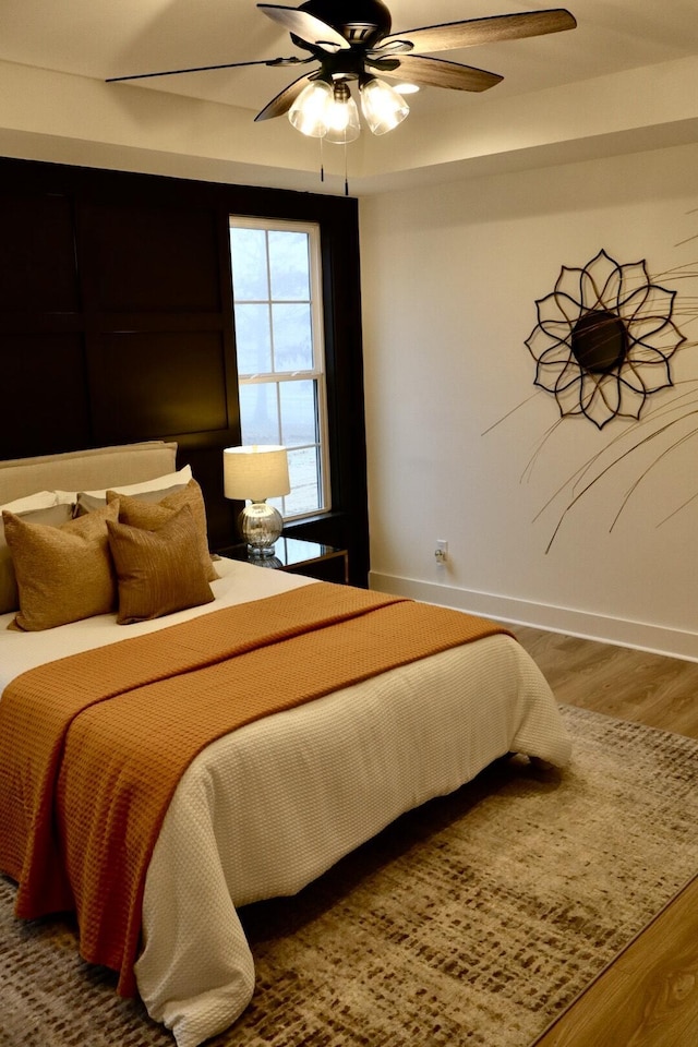 bedroom featuring ceiling fan and hardwood / wood-style floors