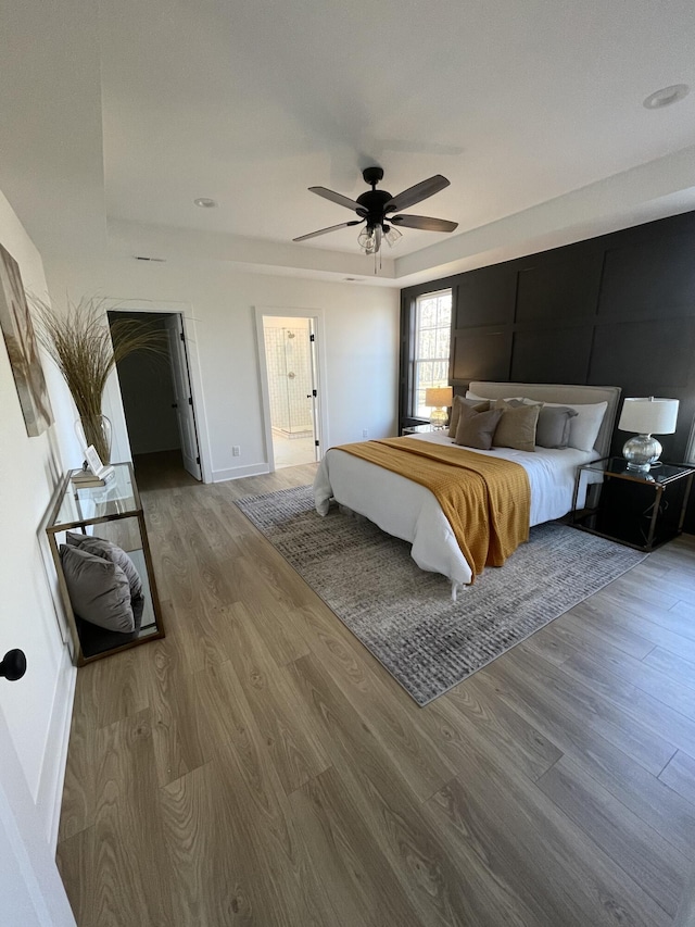 bedroom with ceiling fan and wood-type flooring