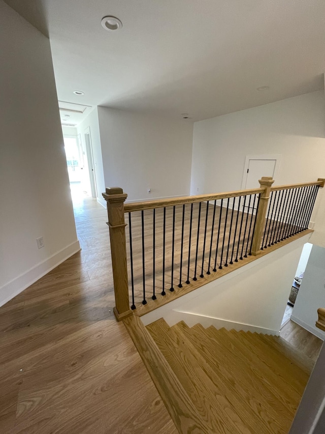 staircase with hardwood / wood-style flooring