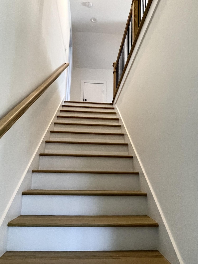 stairway featuring hardwood / wood-style flooring