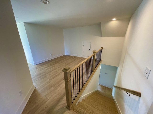 stairway featuring hardwood / wood-style floors