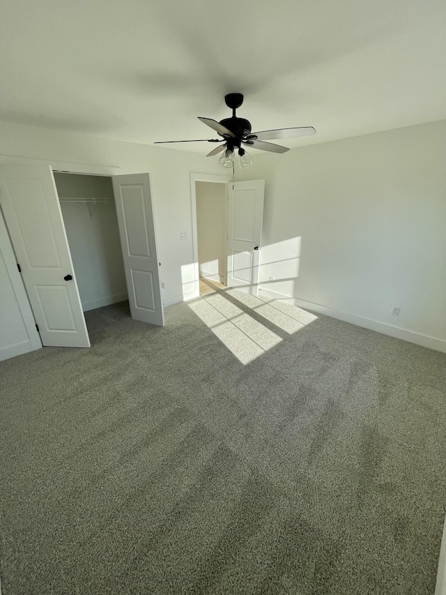 unfurnished bedroom featuring ceiling fan, a closet, and carpet floors