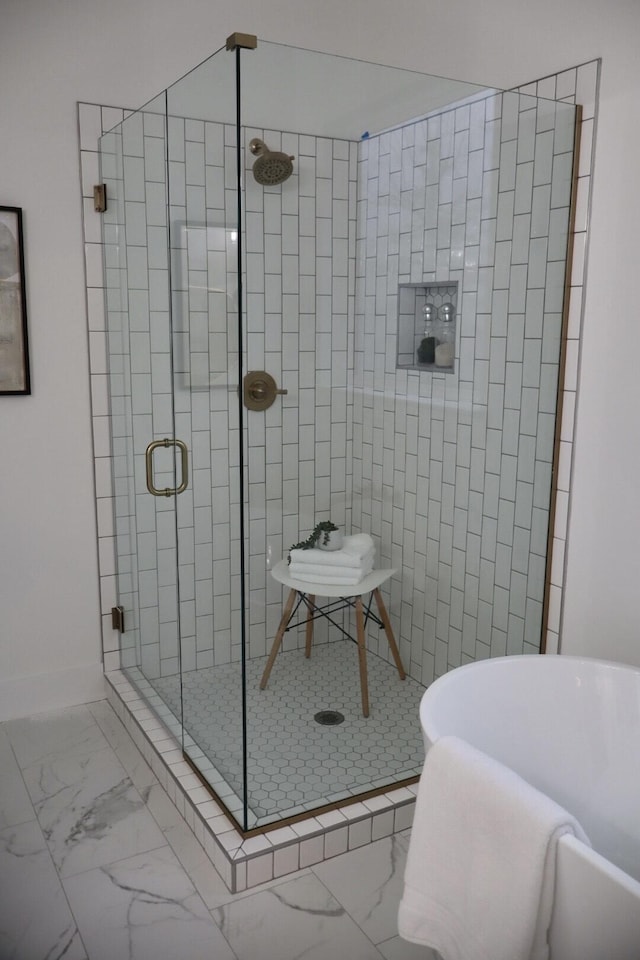 bathroom featuring a shower with door