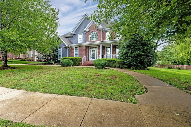 view of front facade with a front yard and covered porch