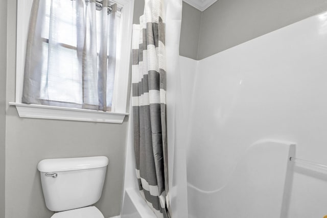 bathroom featuring shower / bath combination with curtain and toilet