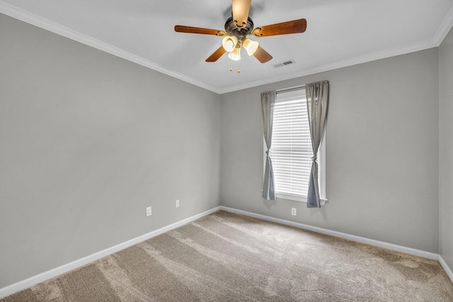 carpeted empty room with ceiling fan and crown molding