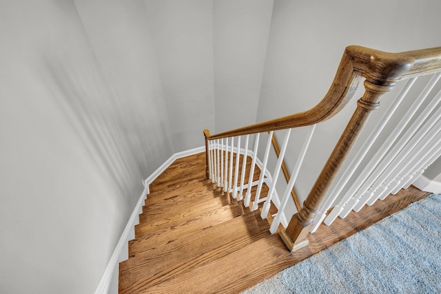 stairs featuring hardwood / wood-style floors