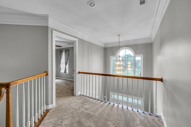 hallway featuring a chandelier, carpet, and ornamental molding