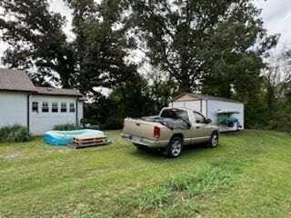 view of yard with a garage and an outdoor structure