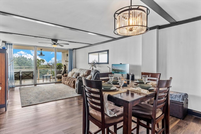 dining area with ceiling fan with notable chandelier, hardwood / wood-style flooring, and crown molding