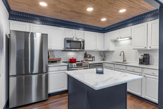 kitchen with white cabinets, dark wood-type flooring, a kitchen island, and stainless steel appliances