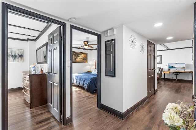 hallway with dark hardwood / wood-style flooring