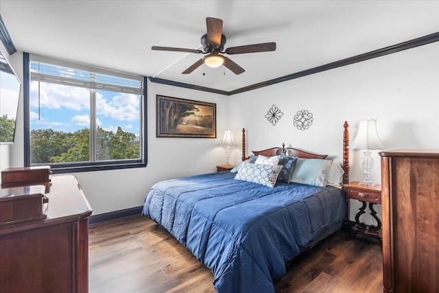 bedroom with crown molding, ceiling fan, and dark wood-type flooring