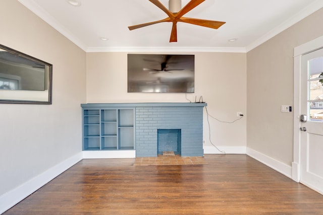 unfurnished living room with baseboards, wood finished floors, a brick fireplace, and ornamental molding