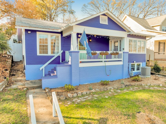 bungalow featuring cooling unit and a porch