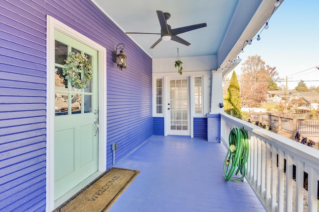 balcony with covered porch and ceiling fan