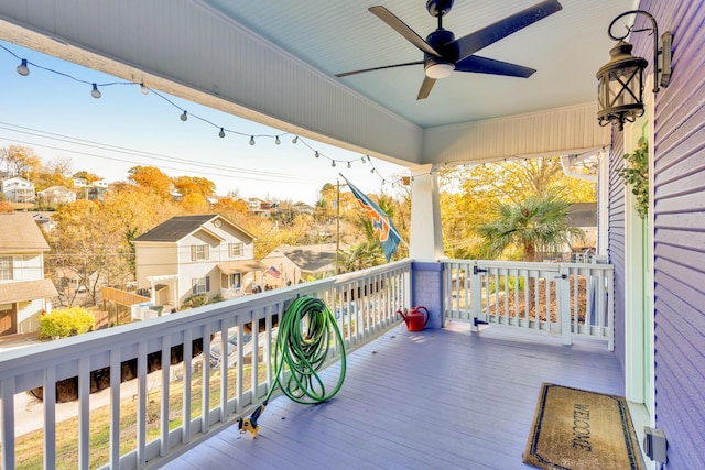 deck featuring a residential view and a ceiling fan