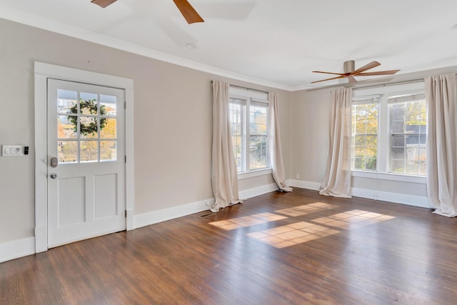 foyer entrance featuring a ceiling fan, crown molding, wood finished floors, and baseboards