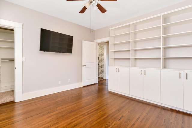 unfurnished bedroom featuring dark wood-type flooring, baseboards, and ceiling fan