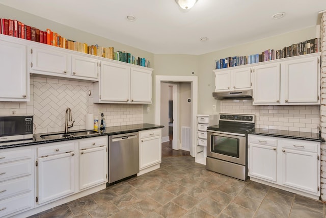 kitchen with a sink, stainless steel appliances, under cabinet range hood, white cabinetry, and backsplash