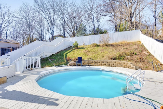 view of pool featuring a fenced backyard, a fenced in pool, and a wooden deck