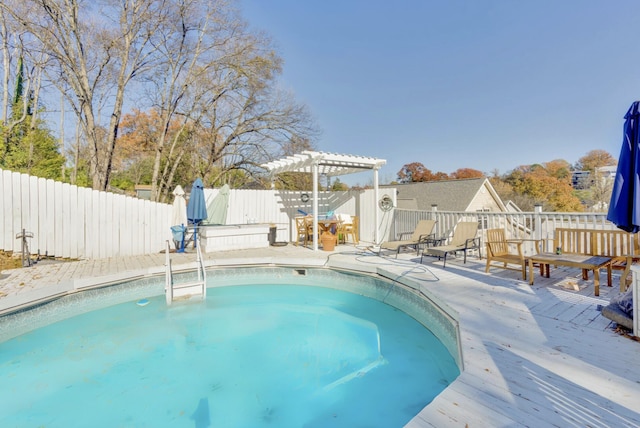 view of swimming pool featuring a hot tub, a pergola, and a fenced backyard