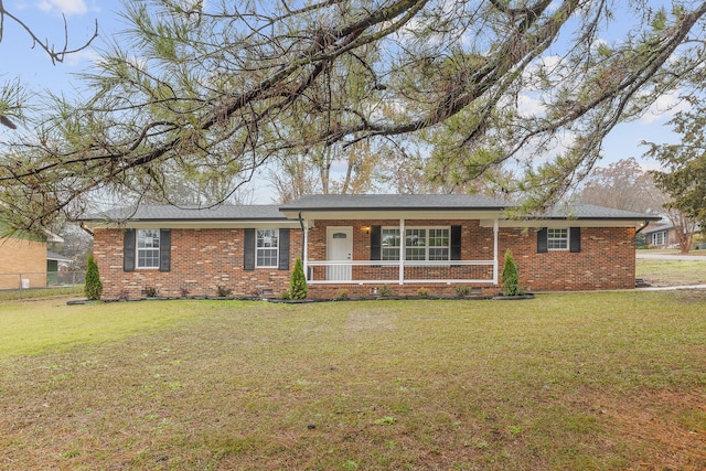 ranch-style home with a front yard and a porch