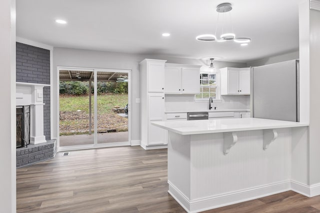 kitchen featuring white cabinets, plenty of natural light, and dishwasher