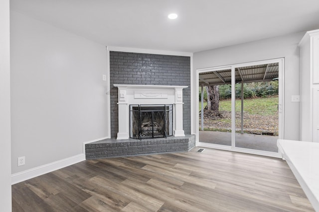 unfurnished living room featuring a fireplace and wood-type flooring