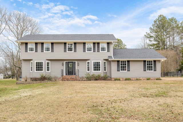 colonial inspired home with a front lawn