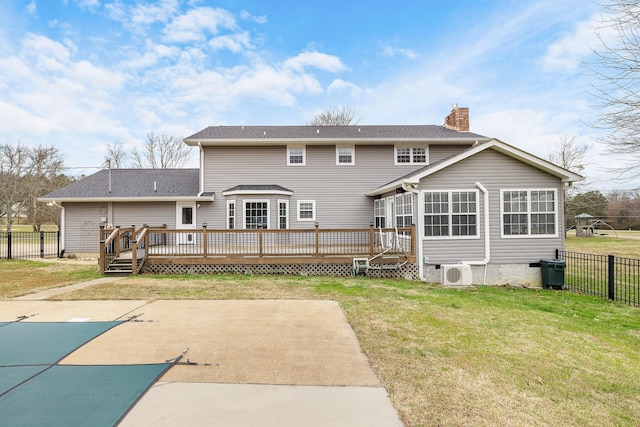 rear view of property with a lawn, a patio area, a swimming pool side deck, and ac unit