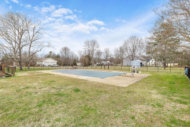 view of swimming pool featuring a lawn