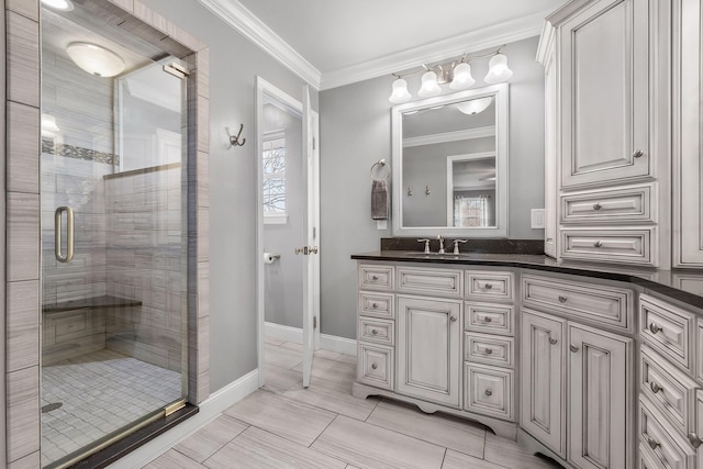 bathroom with vanity, an enclosed shower, and crown molding