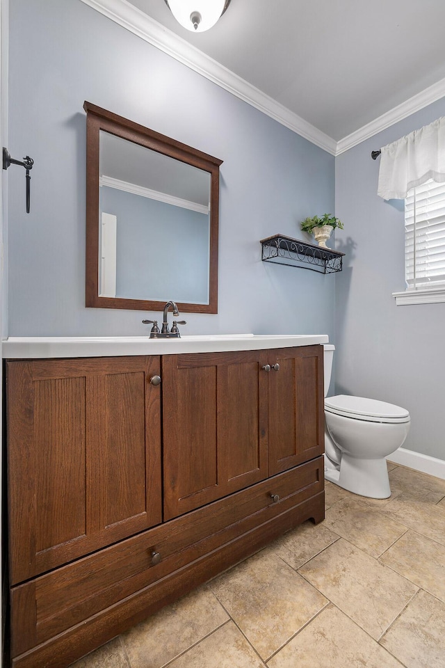 bathroom featuring tile patterned floors, vanity, ornamental molding, and toilet