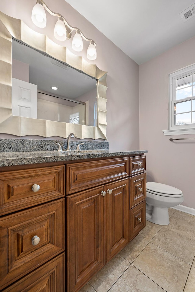 bathroom with tile patterned flooring, vanity, and toilet