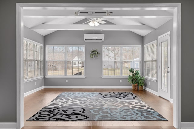 interior space with hardwood / wood-style floors, vaulted ceiling with beams, a wall mounted AC, and ceiling fan