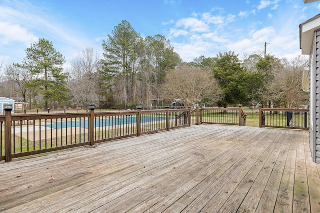 wooden terrace with a fenced in pool