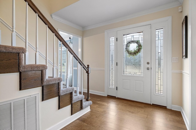 entryway with crown molding and hardwood / wood-style floors