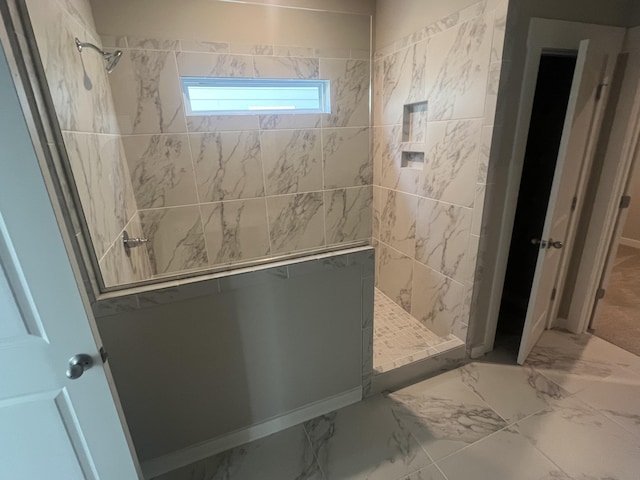 bathroom featuring a tile shower