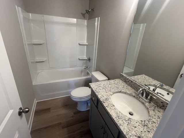 full bathroom with shower / washtub combination, toilet, vanity, and hardwood / wood-style flooring