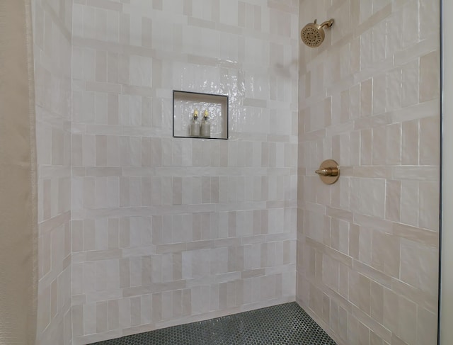 bathroom with a tile shower