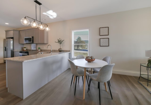 dining space featuring sink and light hardwood / wood-style floors