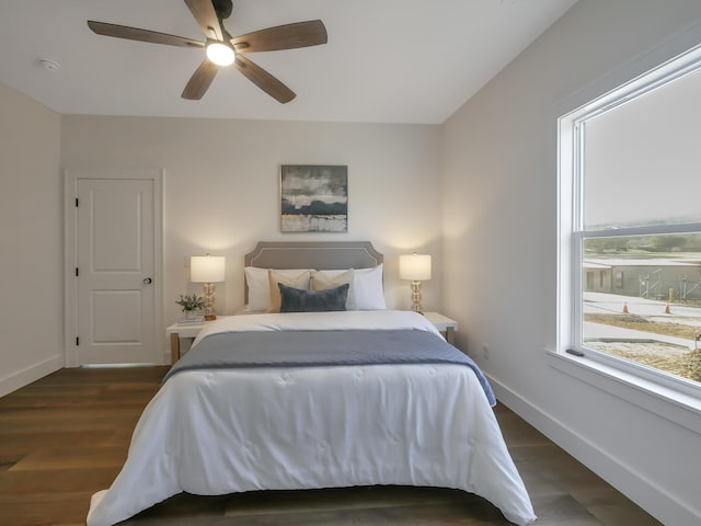 bedroom with ceiling fan and dark hardwood / wood-style flooring