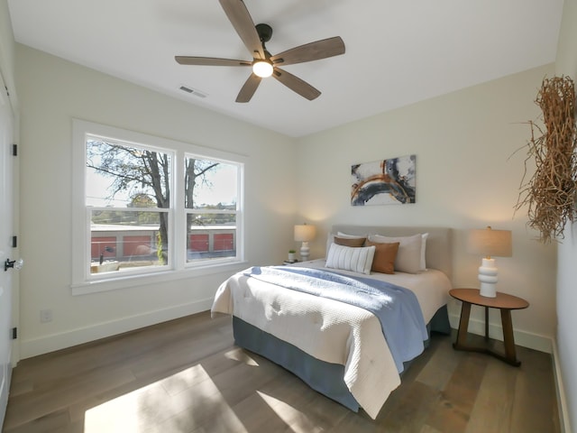 bedroom with ceiling fan and dark hardwood / wood-style floors