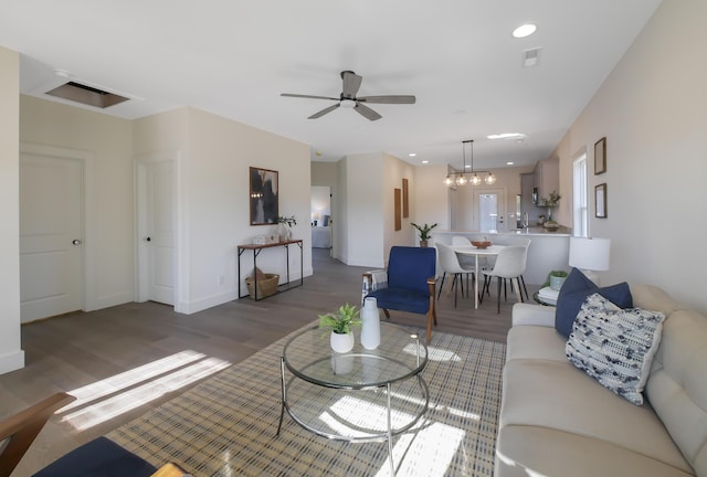 living room featuring ceiling fan and hardwood / wood-style floors