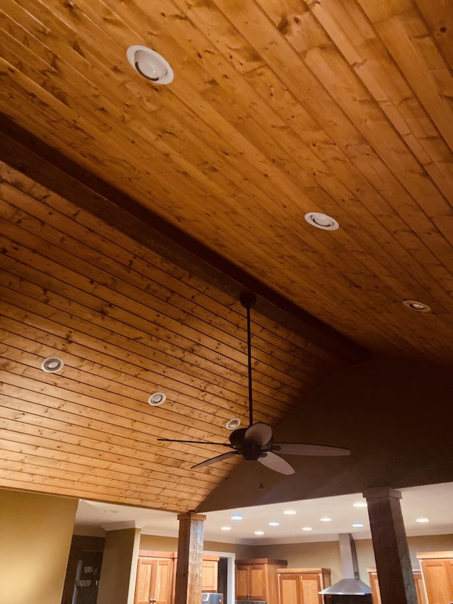 interior details featuring ceiling fan, beamed ceiling, wood ceiling, and wall chimney range hood