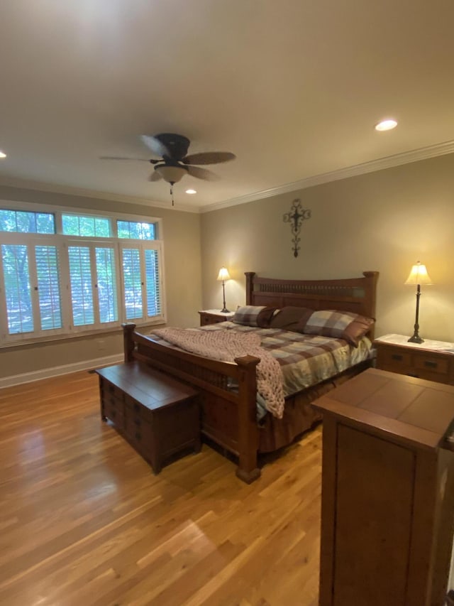 bedroom featuring ceiling fan, crown molding, and light wood-type flooring